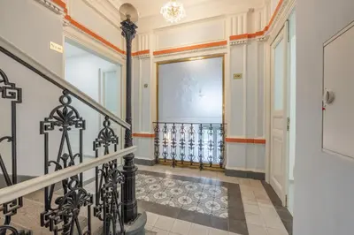 an ornate hallway with a staircase and a large door at HOMELY I Central 38m2 APT I ELEVATOR I Self Check-In in Prague