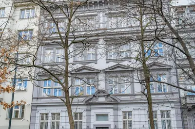 a white building with trees in front of it at HOMELY I Central 38m2 APT I ELEVATOR I Self Check-In in Prague