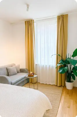 a living room with a couch and a window at HOMELY I Central 38m2 APT I ELEVATOR I Self Check-In in Prague