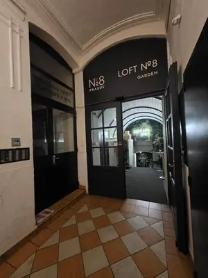an entrance to a building with a lobby with a lotus complex at Cozy Prague Navrátilová in Prague