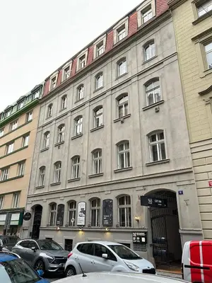 a large building with cars parked in front of it at Cozy Prague Navrátilová in Prague