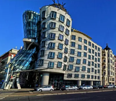 a large building with cars parked in front of it at Cozy Prague Navrátilová in Prague