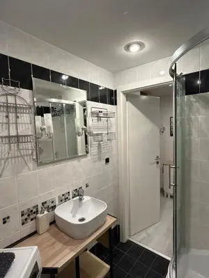 a bathroom with a sink and a shower at Cozy Prague Navrátilová in Prague