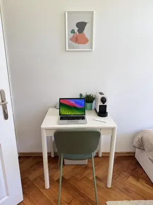 a white desk with a laptop on it in a room at Old Town Green Room with private bathroom in Prague