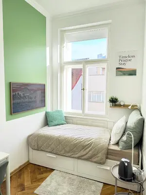 a bed in a room with a window at Old Town Green Room with private bathroom in Prague