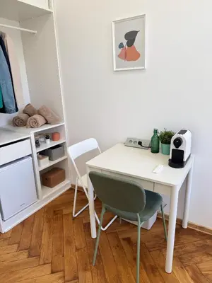 a white desk and two chairs in a room at Old Town Green Room with private bathroom in Prague