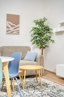 a living room with a couch and a table at Cozy Corner Sokolská by Rentez in Prague