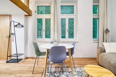 a living room with a table and chairs at Cozy Corner Sokolská by Rentez in Prague