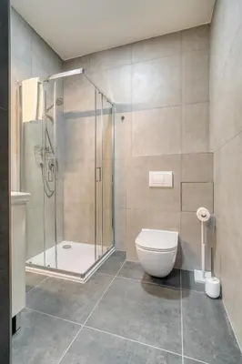 a bathroom with a shower and a toilet at Cozy Corner Sokolská by Rentez in Prague