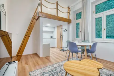 a living room with a table and chairs at Cozy Corner Sokolská by Rentez in Prague