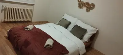 a bedroom with a large bed with pillows at Quiet Apartment Near Prosek Metro, Line C in Prague