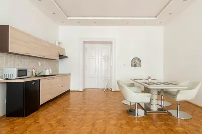 a kitchen with a table and chairs in a room at Prague Centre Apartments in Prague