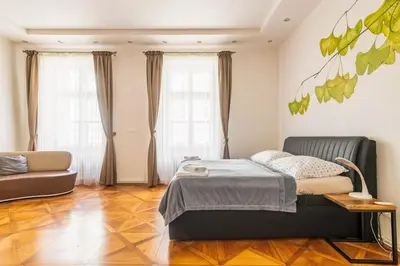 a bedroom with a bed and a couch at Prague Centre Apartments in Prague