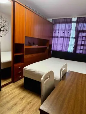 a room with a bed and a table and a bed and a mirror at 2-luzkovy pokoj Praha-13 metro HURKA in Prague