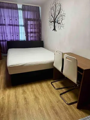 a bedroom with a bed and a table and chairs at 2-luzkovy pokoj Praha-13 metro HURKA in Prague