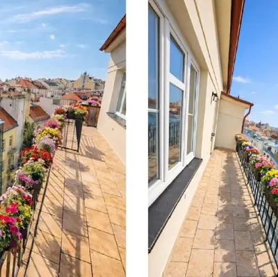 an empty kitchen with white cabinets and a stove at Skyline Terrace Flat in Prague
