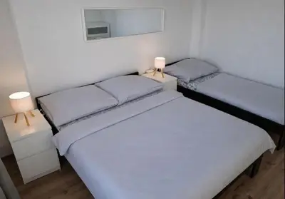 a living room with a table and a bed and a room with a view at Skyline Terrace Flat in Prague