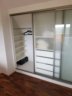 a closet with glass doors in a room at Lucky 55 in Prague