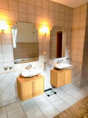 a bathroom with two sinks and a large mirror at Lucky 55 in Prague