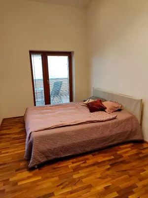 a bedroom with a large bed with a window at Lucky 55 in Prague