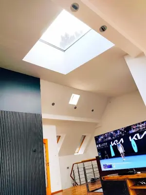 a living room with a skylight in the ceiling at Lucky 55 in Prague
