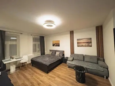 a living room with a bed and a couch at florenc apartments prague by kalab in Prague