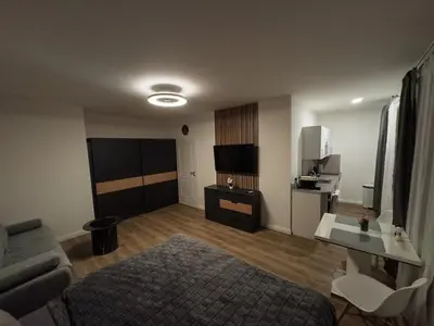 a living room with a bed and a kitchen at florenc apartments prague by kalab in Prague