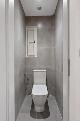 a bathroom with a white toilet in a room at Simple and Cozy in Prague