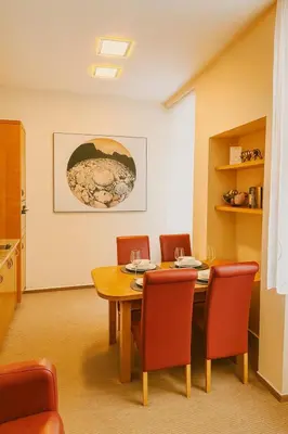 a dining room with a wooden table and chairs at Maisonette apartment in the center of Prague - Samcova in Prague