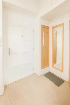 a white room with a closet and a door at Maisonette apartment in the center of Prague - Samcova in Prague