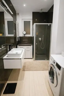 a bathroom with a sink and a washing machine at Exclusive Apartment with Terrace, View & Jacuzzi in Prague