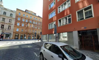 a white car parked in front of a building at Exclusive Apartment with Terrace, View & Jacuzzi in Prague