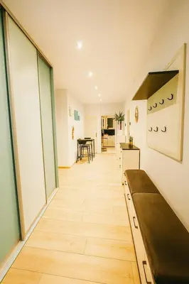 a hallway of a room with a kitchen and a table at Exclusive Apartment with Terrace, View & Jacuzzi in Prague