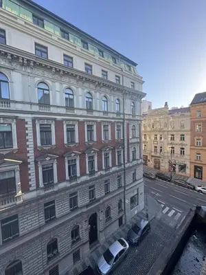 a building with two cars parked in front of it at Exclusive Apartment with Terrace, View & Jacuzzi in Prague