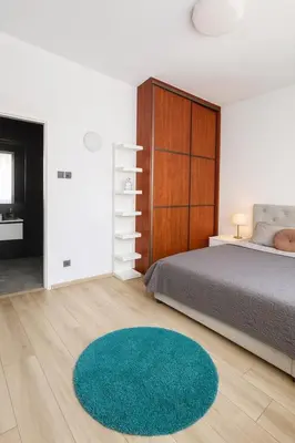 a bedroom with a bed and a green rug at Exclusive Apartment with Terrace, View & Jacuzzi in Prague