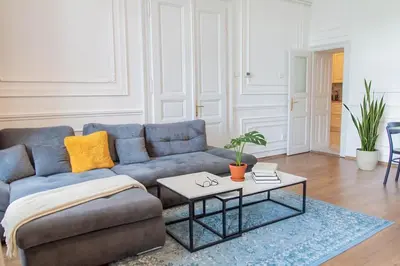 a living room with a blue couch and a table at Spacious APT by Wenceslas Square & National Museum in Prague