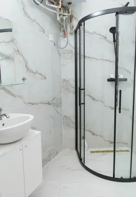 a shower with a glass door in a bathroom at Spacious APT by Wenceslas Square & National Museum in Prague