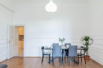 a dining room with a table and blue chairs at Spacious APT by Wenceslas Square & National Museum in Prague