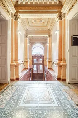 an ornate hallway with a door and a tile floor at Spacious APT by Wenceslas Square & National Museum in Prague