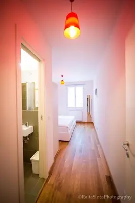 a bathroom with a sink and a bed in a room at Riverside Grande in Prague