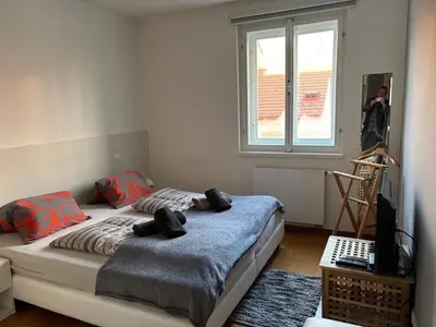 a bedroom with two beds and a window at Riverside Grande in Prague