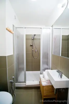 a bathroom with a shower and a sink at Riverside Grande in Prague