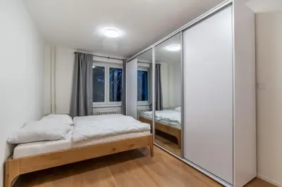 a bedroom with two beds and a mirror at Prague Family Apartment in Prague