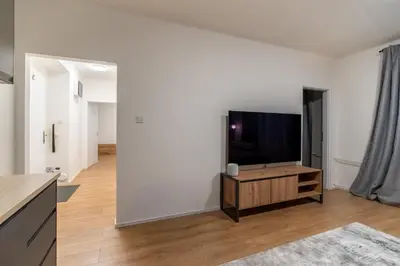 a living room with a flat screen tv on a white wall at Prague Family Apartment in Prague