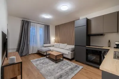 a living room with a couch and a table at Prague Family Apartment in Prague