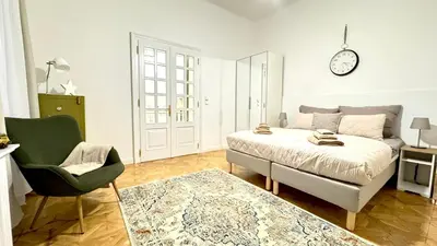 a bedroom with a bed and a chair and a clock at Night next to the Museum in Prague