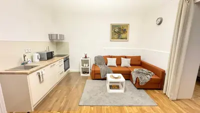 a living room with a couch and a kitchen at Night next to the Museum in Prague