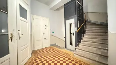 a hallway with stairs and a checkered floor at Night next to the Museum in Prague