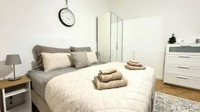 a bedroom with a bed with towels on it at Night next to the Museum in Prague