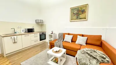 a living room with a couch and a kitchen at Night next to the Museum in Prague